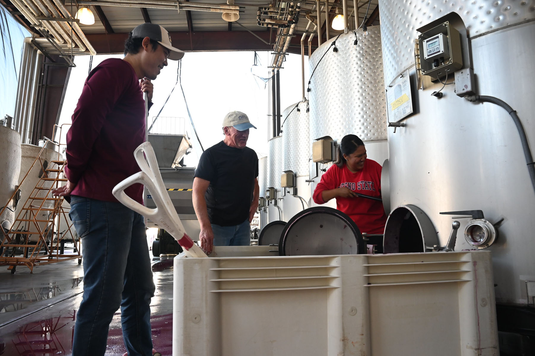 student working at the winery